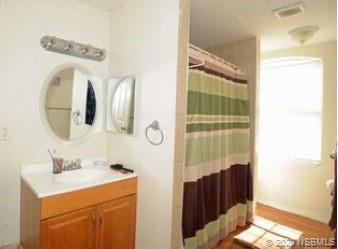 415 Stacy Grove Road Oak Hill, FL 32759 - Photo 24 of 25 a bathroom with a sink and mirror