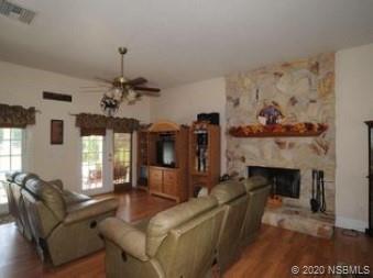 415 Stacy Grove Road Oak Hill, FL 32759 - Photo 7 of 25 a living room with furniture and a fireplace