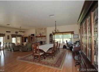 415 Stacy Grove Road Oak Hill, FL 32759 - Photo 8 of 25 a view of a dining room with furniture window and wooden floor