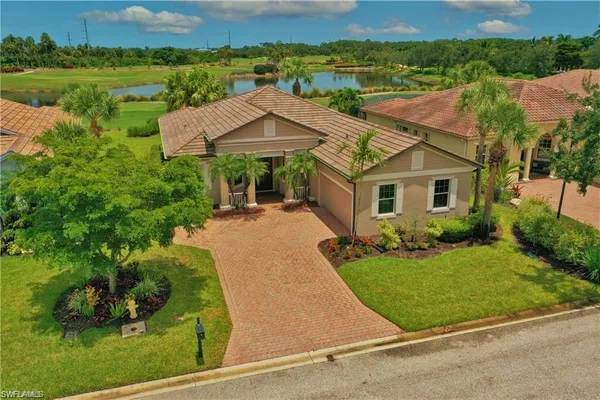 an aerial view of a house with yard porch and furniture