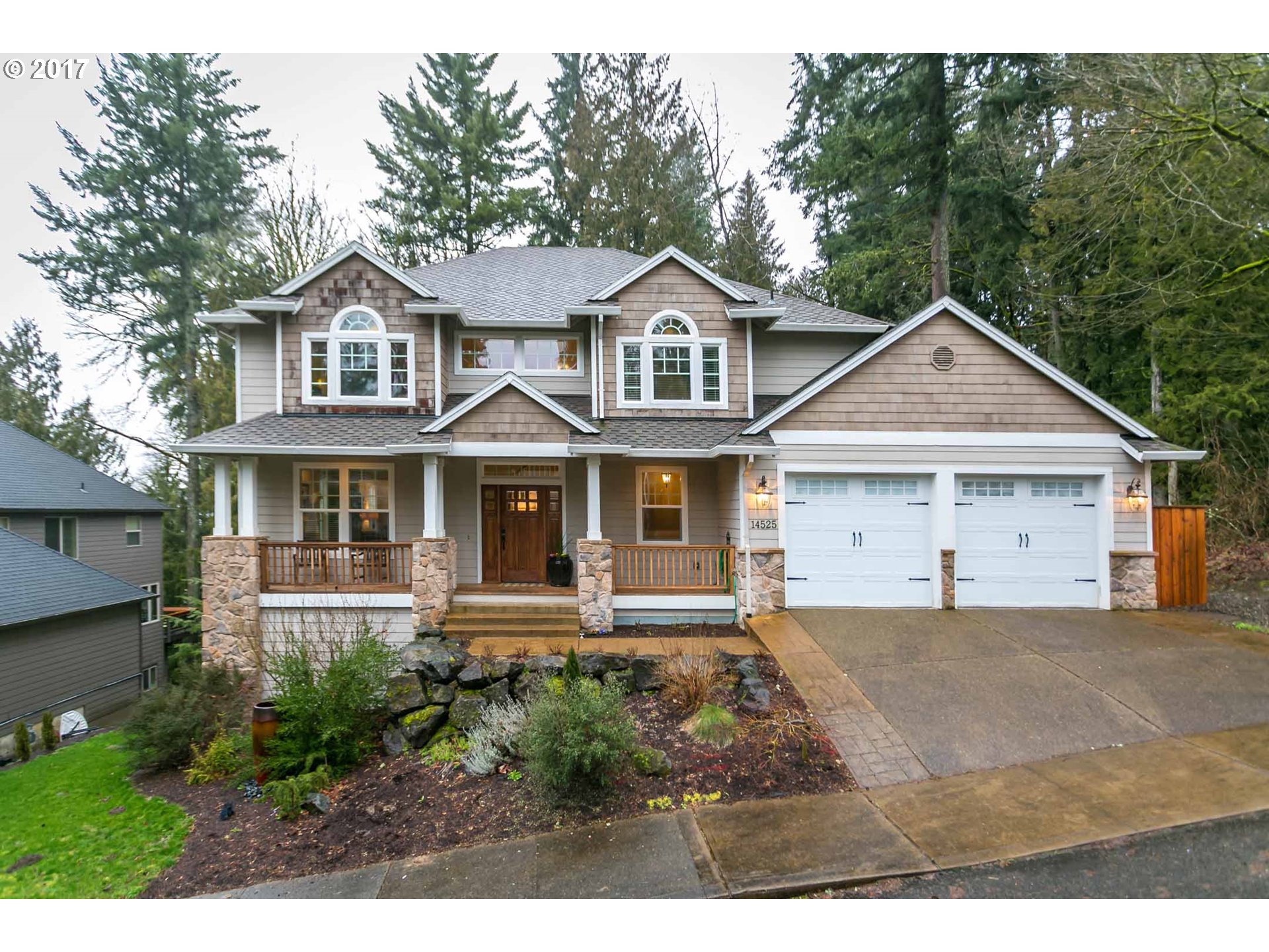 a front view of a house with a yard and trees