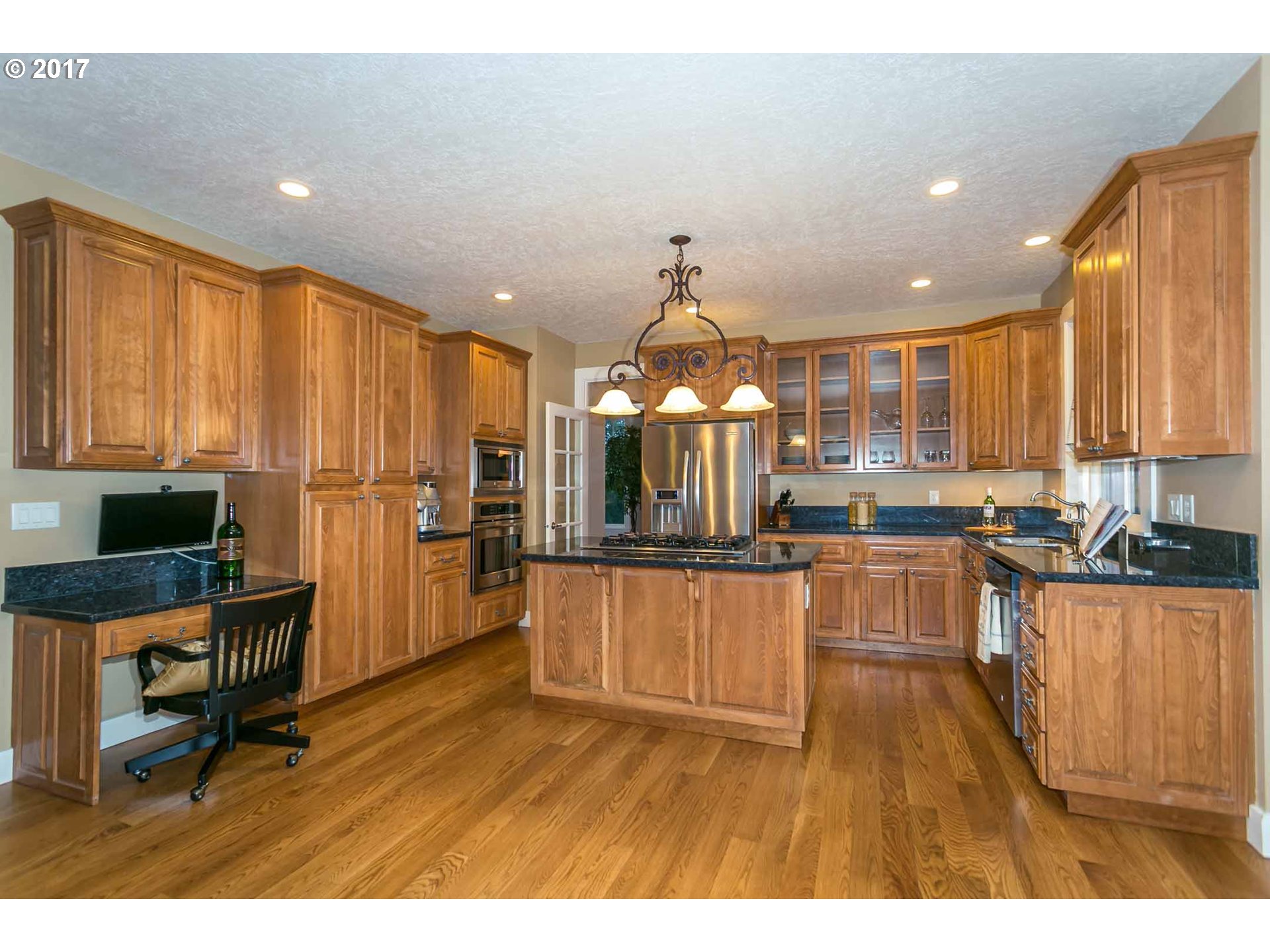 14525 Southeast Duke Street Portland, OR 97236 - Photo 11 of 27 a kitchen with stainless steel appliances kitchen island granite countertop a refrigerator a stove top oven a sink and dishwasher
