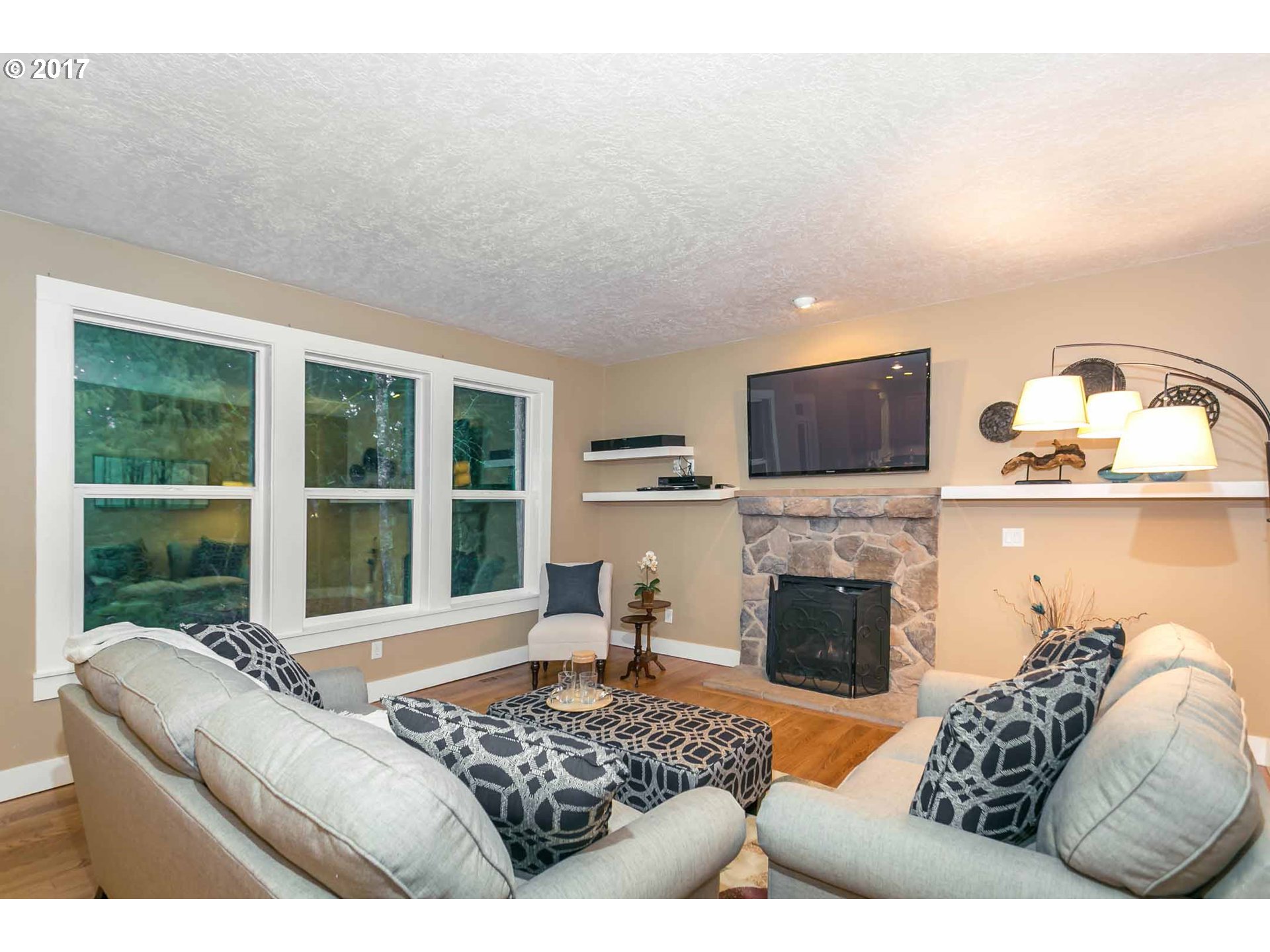 14525 Southeast Duke Street Portland, OR 97236 - Photo 13 of 27 a living room with furniture fireplace and a flat screen tv