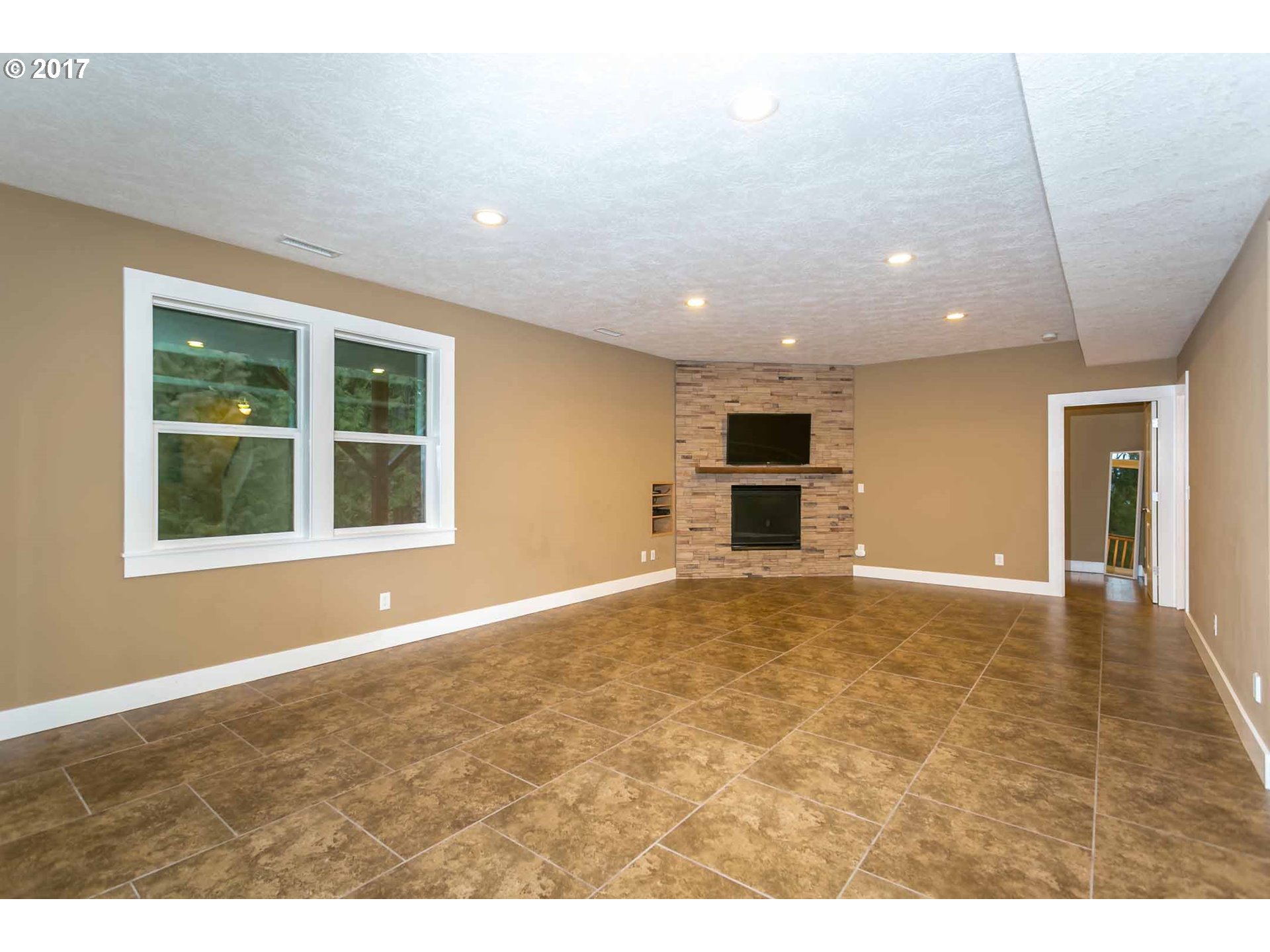 14525 Southeast Duke Street Portland, OR 97236 - Photo 24 of 27 a view of empty room with a fireplace and windows