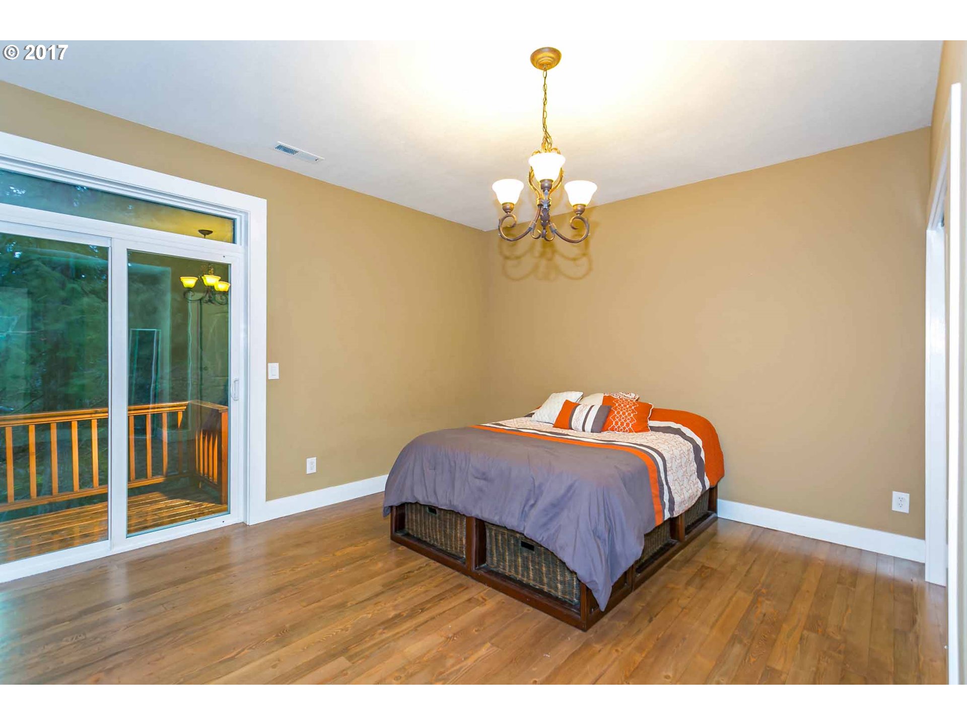 14525 Southeast Duke Street Portland, OR 97236 - Photo 25 of 27 a bedroom with a bed and wooden floor