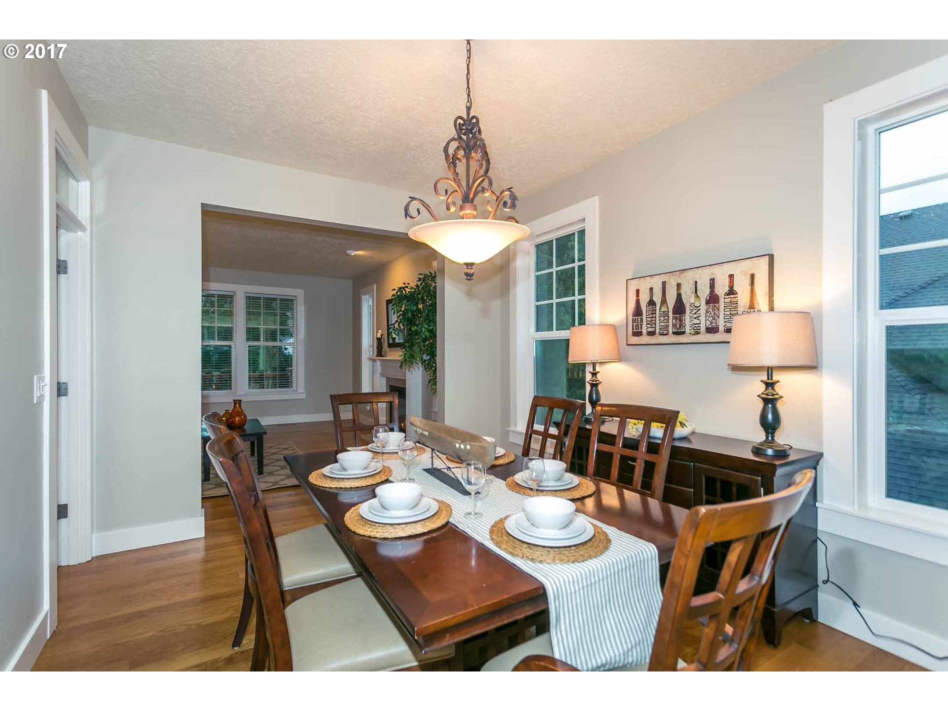 14525 Southeast Duke Street Portland, OR 97236 - Photo 8 of 27 a dining room with furniture a chandelier and wooden floor