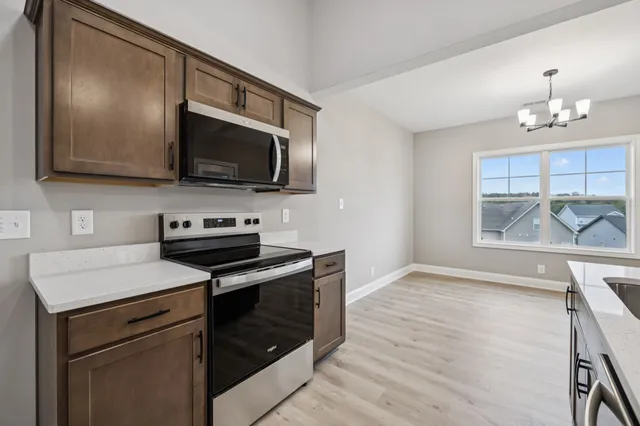 a kitchen with a stove and a microwave