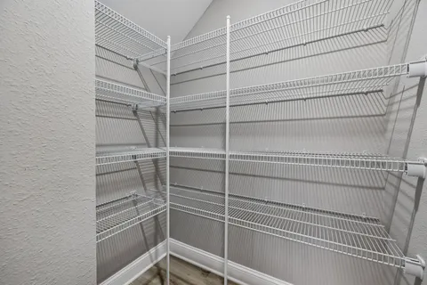 a view of walk in closet with empty racks