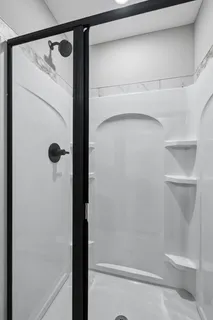 a bathroom with a glass shower door