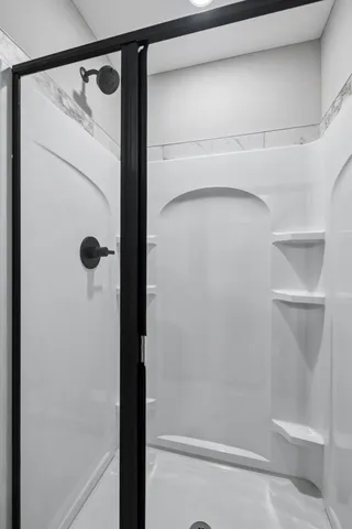 a bathroom with a glass shower door