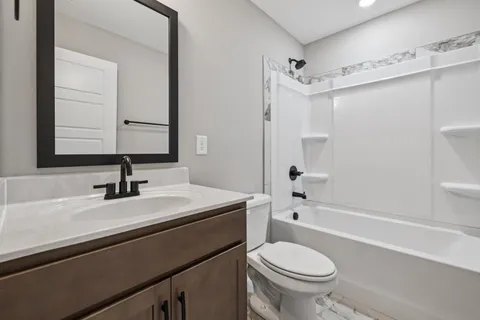 a bathroom with a sink a toilet and a mirror