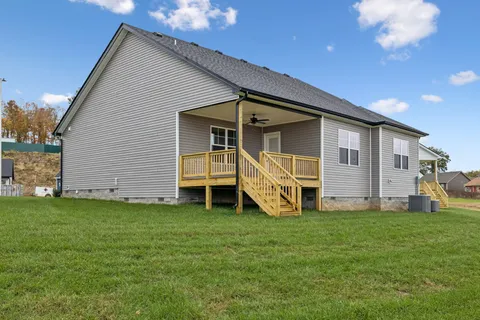 a view of a house with a yard and porch