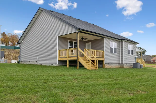 a view of a house with a yard and porch