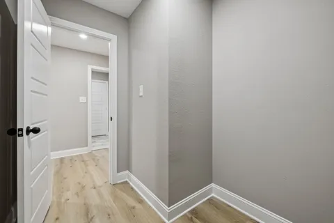 a view of hallway with wooden floor
