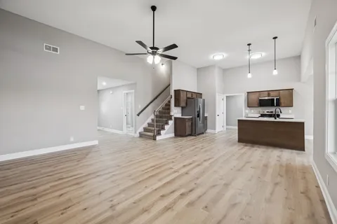 a view of kitchen with sink microwave and stove