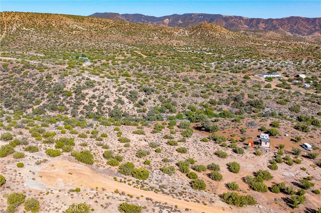 26000 Arabian Place Tehachapi, CA 93561 - Photo 11 of 17 a view of a field with a mountain in the background