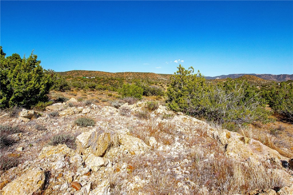 26000 Arabian Place Tehachapi, CA 93561 - Photo 9 of 17 a view of a large building with mountains in the background