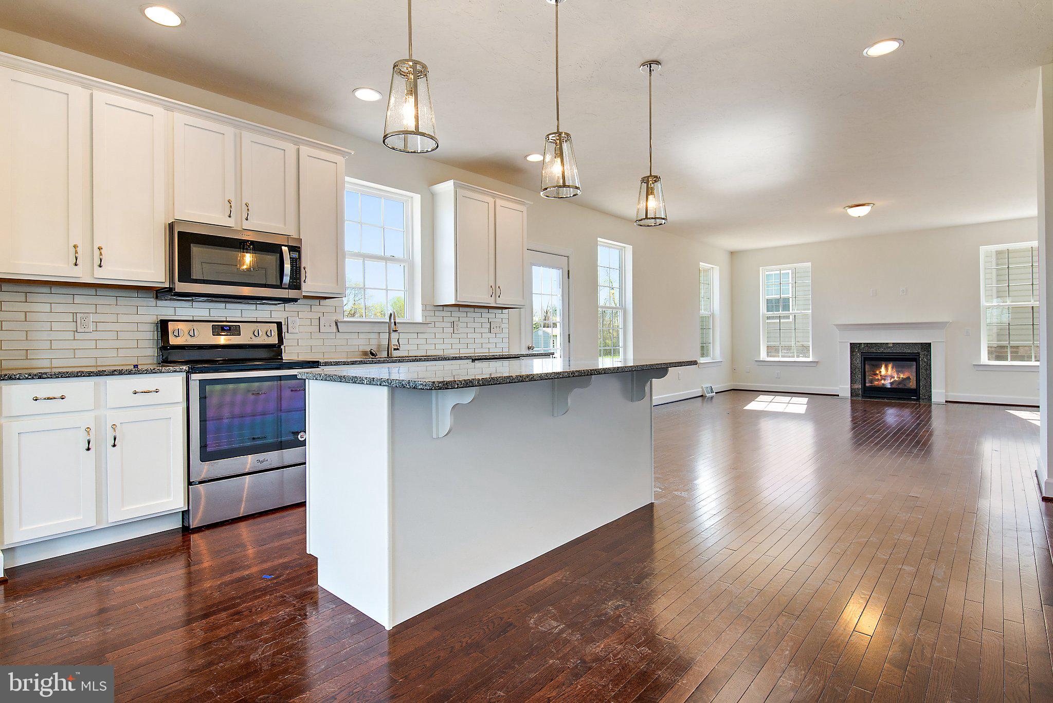 53 Bright Lane Hanover, PA 17331 - Photo 8 of 21 a kitchen with stainless steel appliances granite countertop a refrigerator a stove a sink dishwasher and a oven with white cabinets