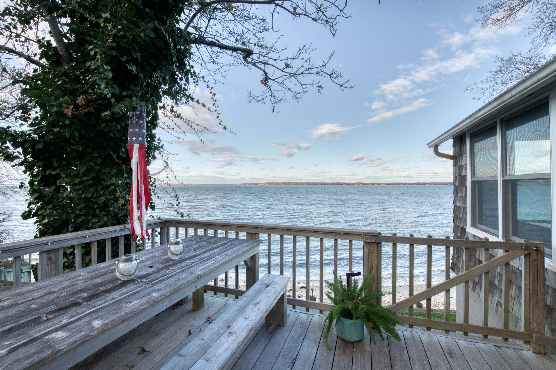 3675 Noyack Road Sag Harbor, NY 11963 - Photo 2 of 12 a terrace with wooden floor barbeque oven and yard in the back
