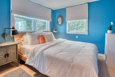 a bedroom with a large bed and a window