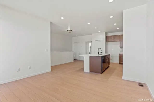 a view of a kitchen with a sink and a refrigerator