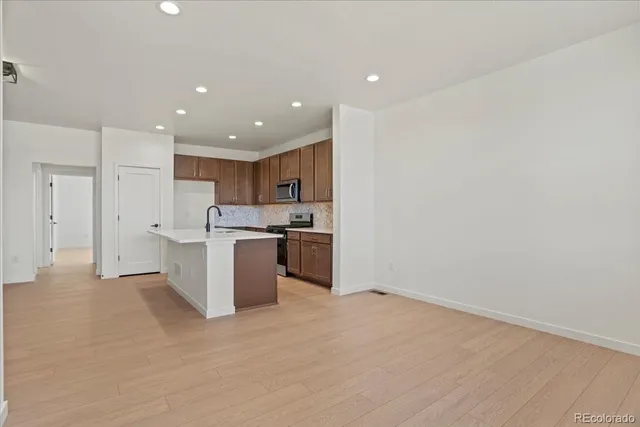 a kitchen with a refrigerator and white cabinets