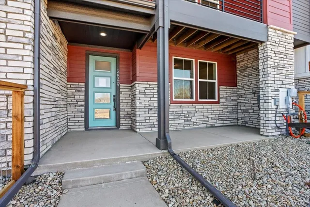a view of a brick house with large windows