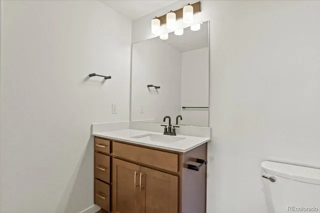 a bathroom with a sink a light fixture and a mirror