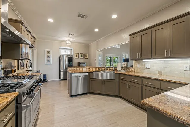 a kitchen with lots of counter top space and appliances