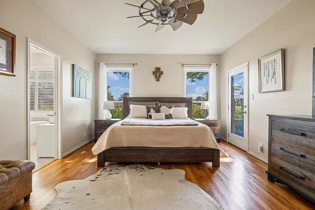 a bedroom with a large bed and a window