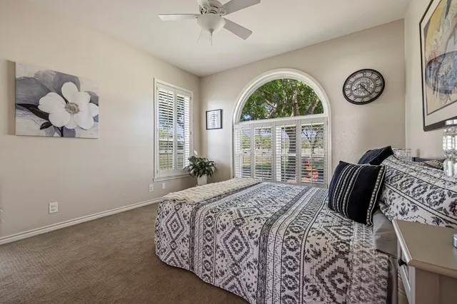 a bedroom with a large bed and a window