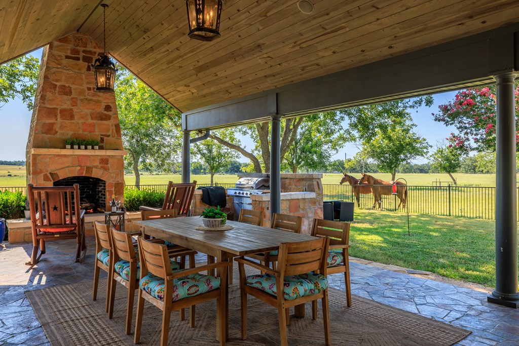 234 Nelson-rouse Road Fredericksburg, TX 78624 - Photo 25 of 41 a view of a patio with a table chairs and a backyard