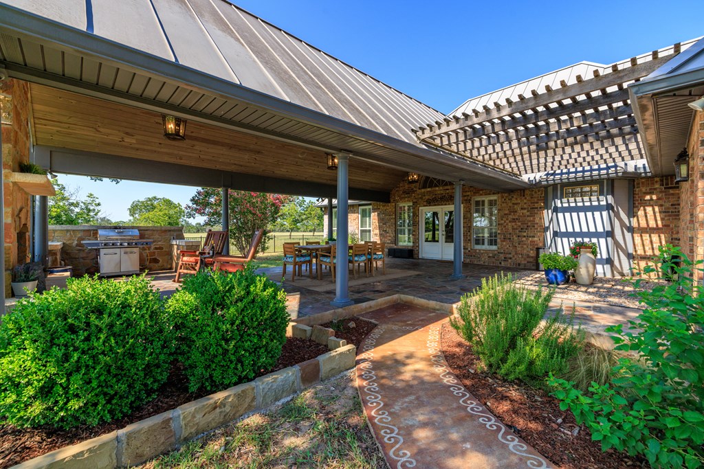 234 Nelson-rouse Road Fredericksburg, TX 78624 - Photo 29 of 41 a view of a patio with table and chairs potted plants