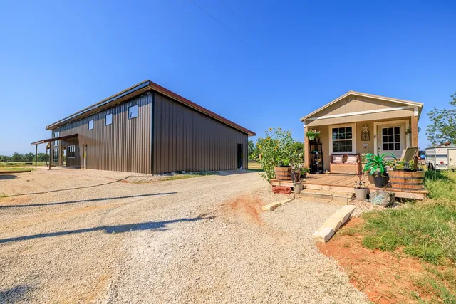 a view of a house with backyard sitting area and porch