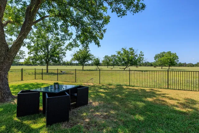 a view of a yard with wooden fence