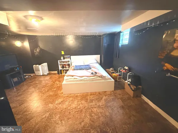 a spacious bedroom with a bed and a window