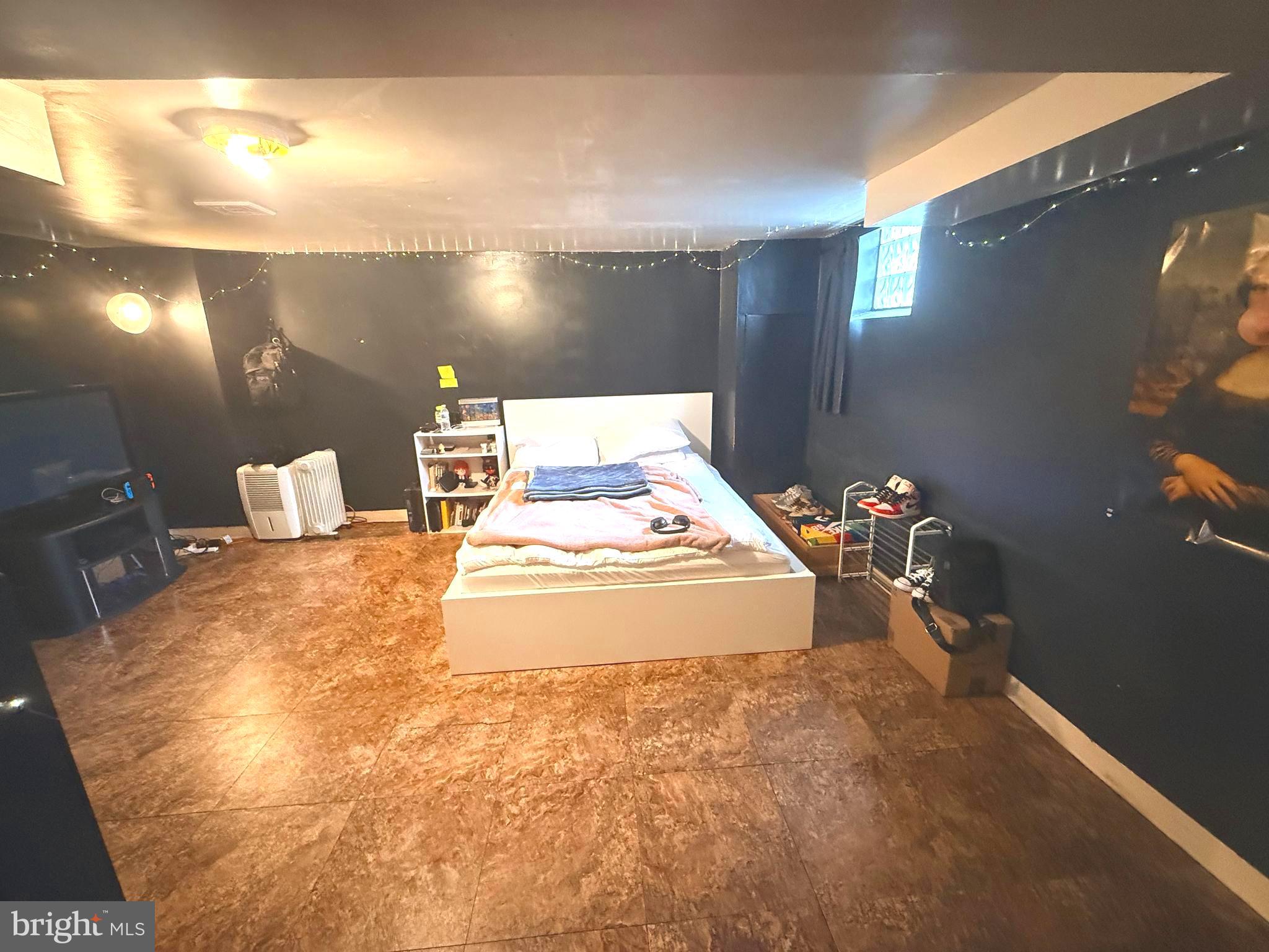 7820 Wynbrook Road Baltimore, MD 21224 - Photo 13 of 18 a spacious bedroom with a bed and a window