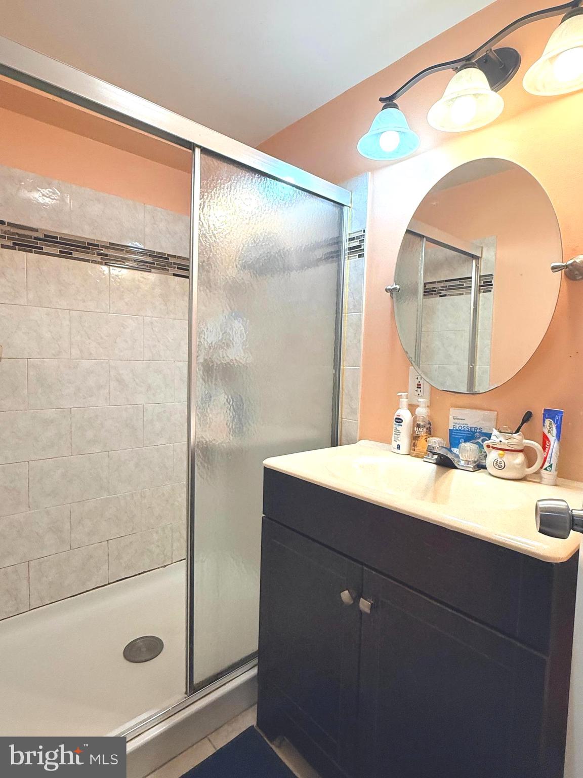 7820 Wynbrook Road Baltimore, MD 21224 - Photo 14 of 18 a bathroom with a sink mirror and shower