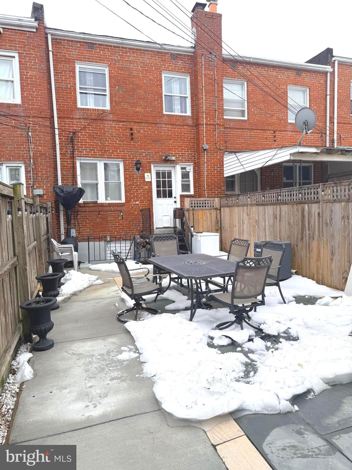 7820 Wynbrook Road Baltimore, MD 21224 - Photo 17 of 18 a view of a patio with a table and chairs