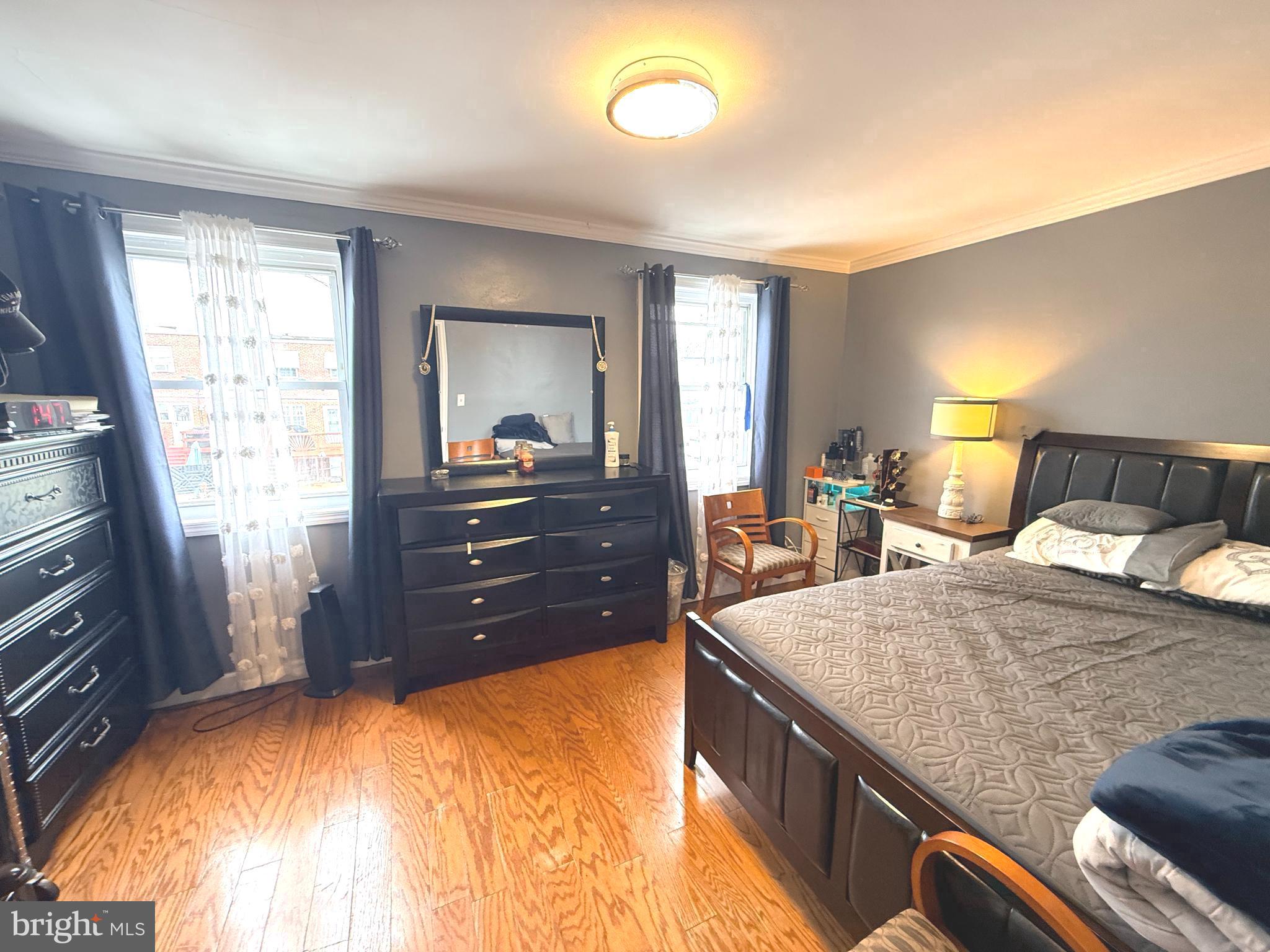 7820 Wynbrook Road Baltimore, MD 21224 - Photo 9 of 18 a bedroom with a bed and wooden floor