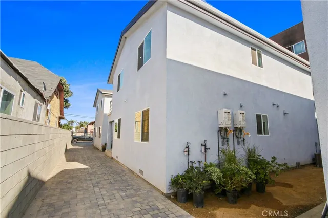 a view of a street with potted plants