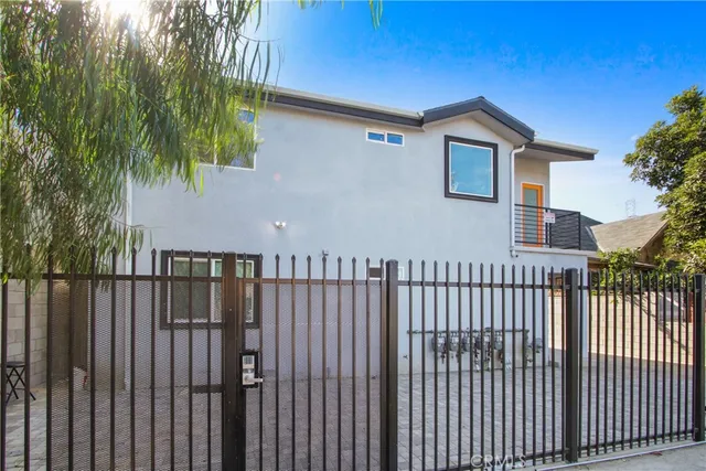 a view of a house with wooden fence