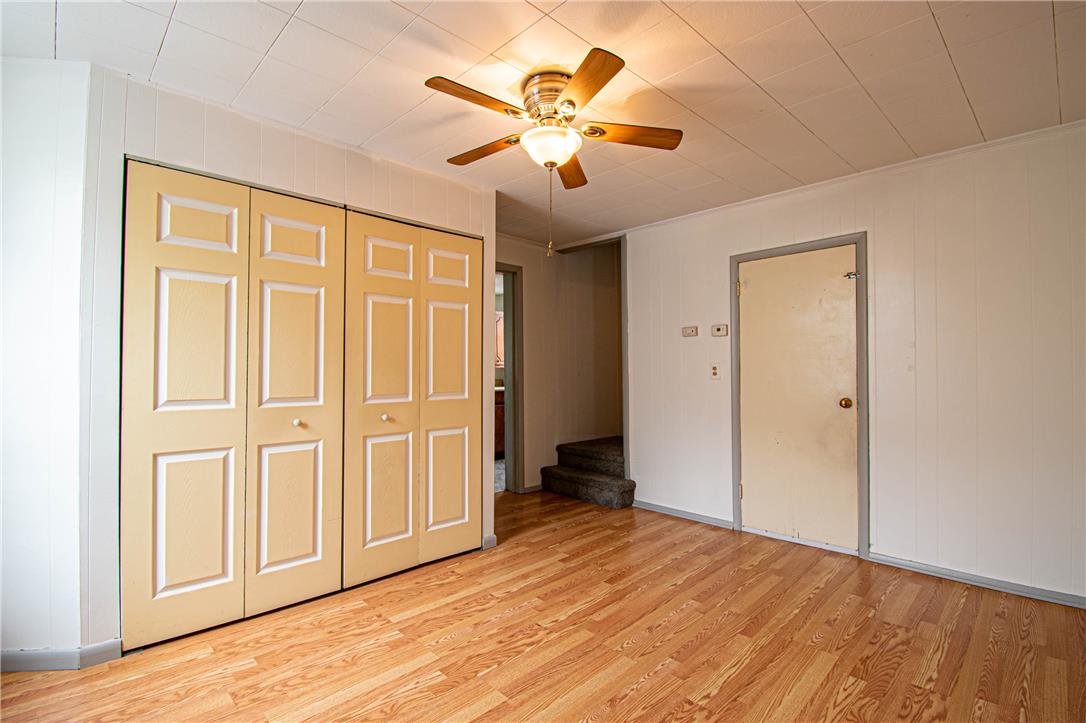 27 West Allen Street Allentown, PA 18102 - Photo 9 of 26 Natural wood flooring complements built-in closet doors, topped by a classic ceiling fan.