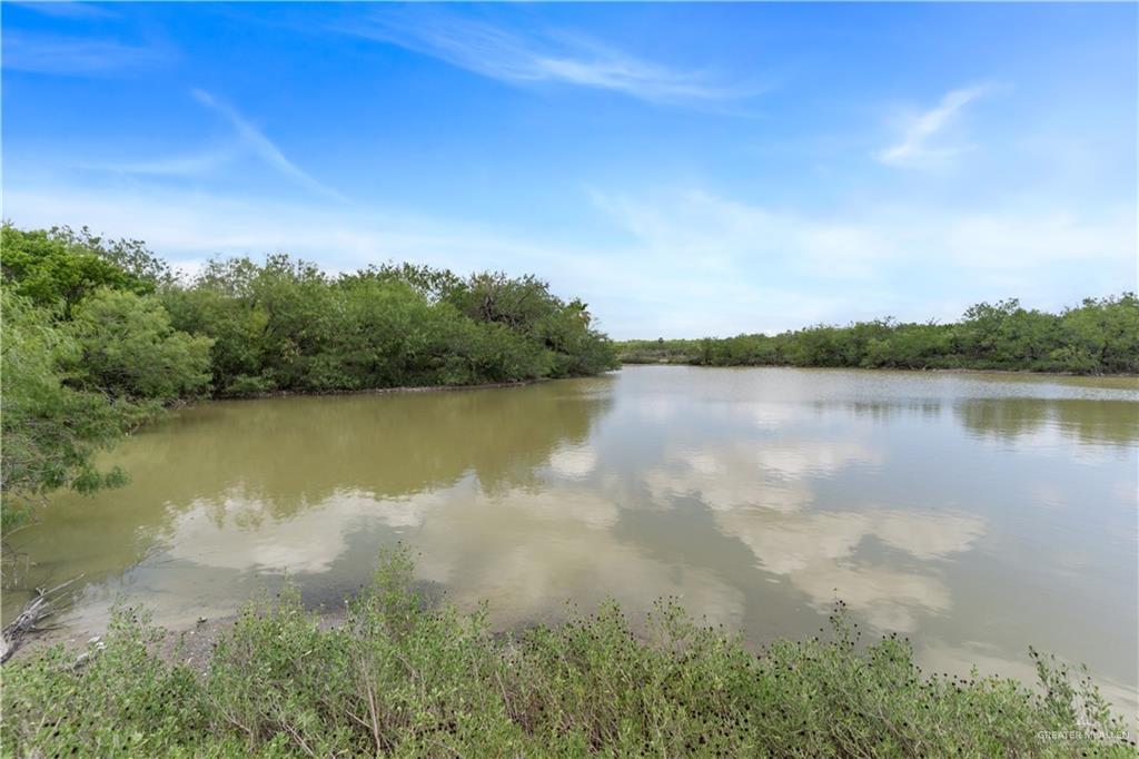 0 Military Road Penitas, TX 78576 - Photo 15 of 26 a view of a lake with houses in the back