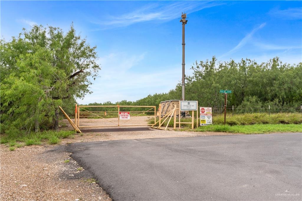 0 Military Road Penitas, TX 78576 - Photo 23 of 26 a view of a road with a big yard and palm trees
