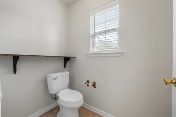 a white toilet sitting next to a window