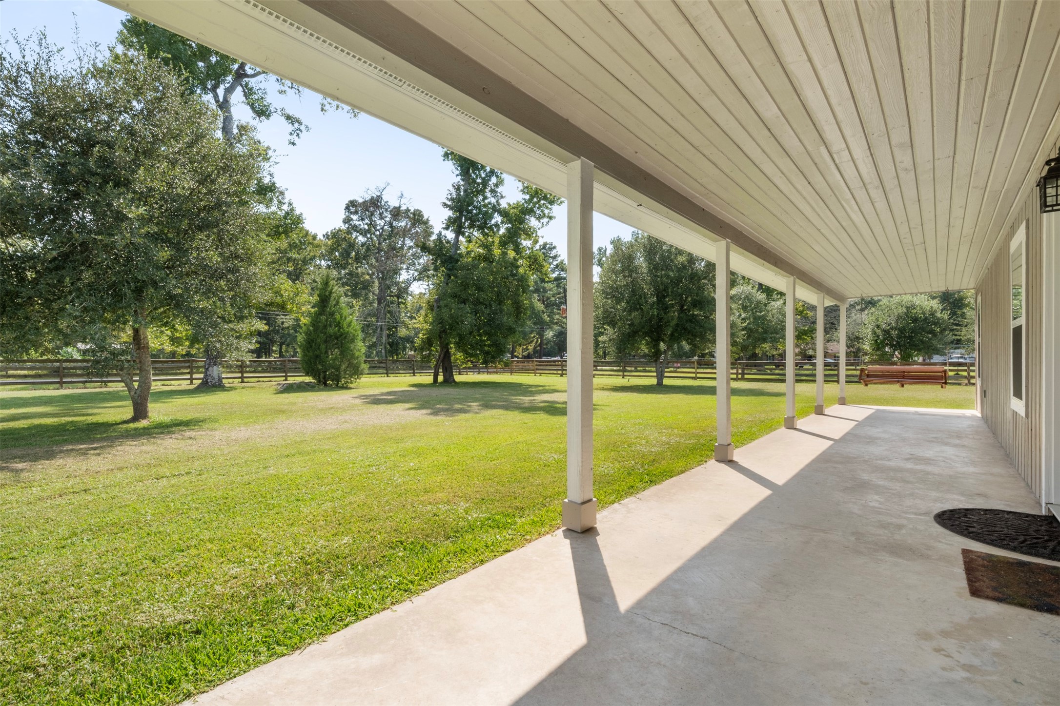 28081 Ivy Oaks Lane Splendora, TX 77372 - Photo 3 of 27 a view of swimming pool with lawn chairs and large trees