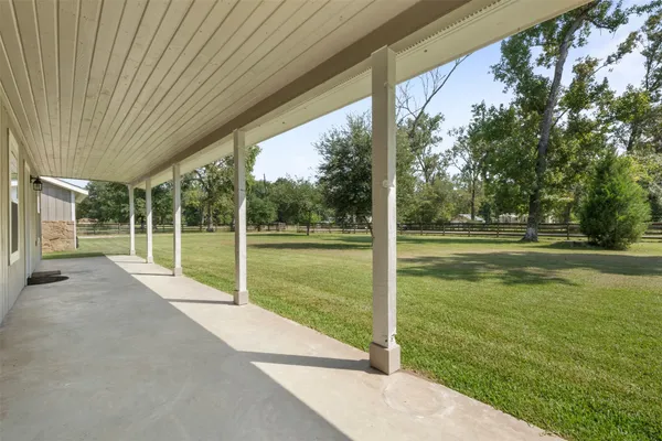 a view of a house with a big yard and palm trees