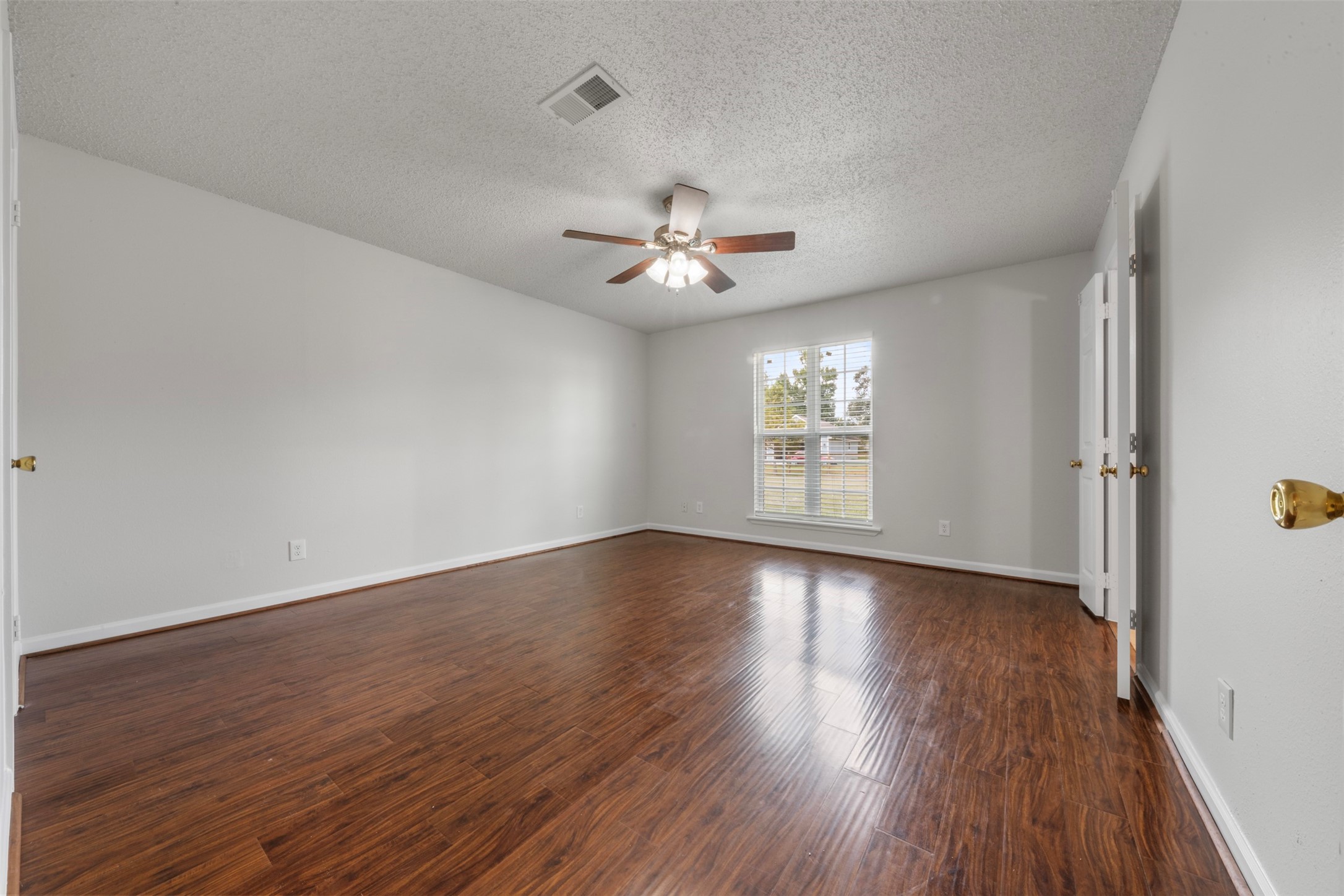28081 Ivy Oaks Lane Splendora, TX 77372 - Photo 8 of 27 wooden floor in an empty room with a window