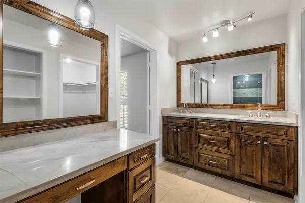a spacious bathroom with a granite countertop sink and a mirror